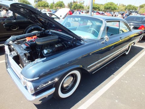 Dark blue Ford Starliner hardtop, hood open, with light blue interior