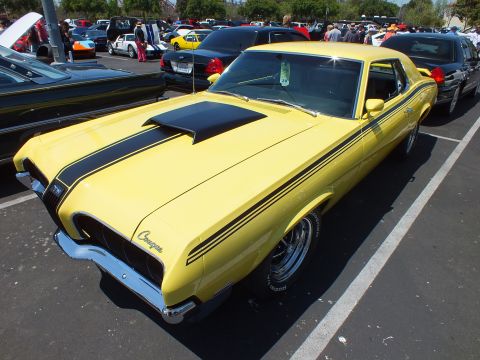 Yellow Mercury Cougar with black stripes, front three-quarter at a show