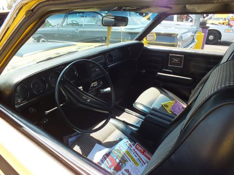 Interior of a Mercury Cougar showing dash, steering wheel and seats