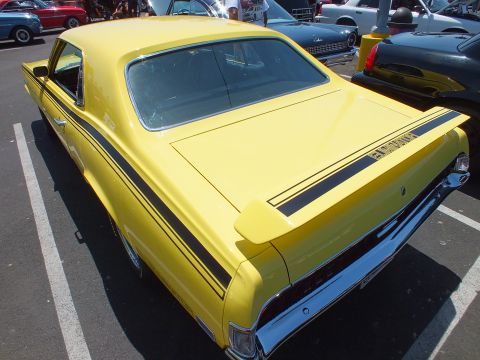 Rear three-quarter of a yellow Mercury Cougar Eliminator with spoiler