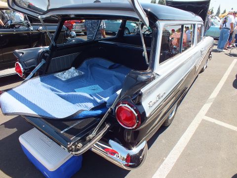 Open rear tailgate and cargo area of a 1950s station wagon
