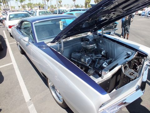 Silver and purple two-door coupe with open hood at a car show