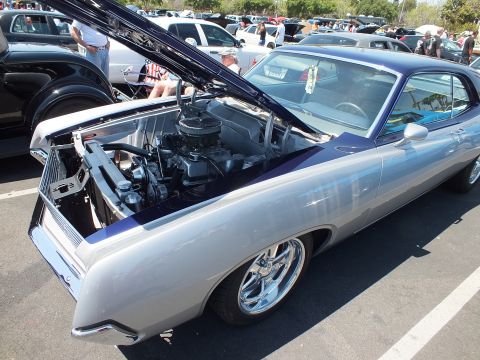 Silver and purple two-door fastback coupe with open hood, front quarter view