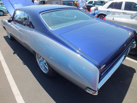 Silver and blue two-door coupe rear three-quarter view in a parking lot