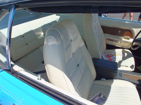 White vinyl bucket seats inside a blue Mustang interior