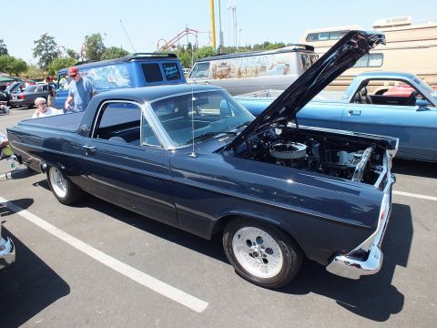 Dark gray Ford Ranchero coupe-utility with raised hood and chrome wheels