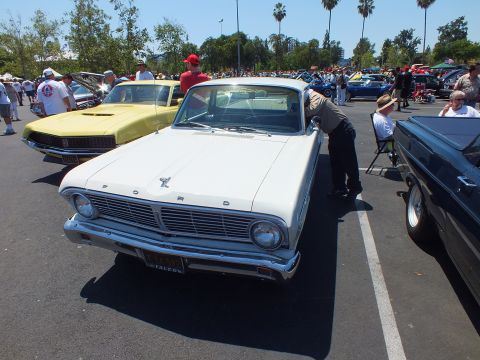 White Ford Falcon coupe-utility with FORD lettering on the hood at a car show