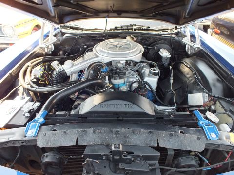 Engine bay with chrome air cleaner and CAUTION FAN shroud label