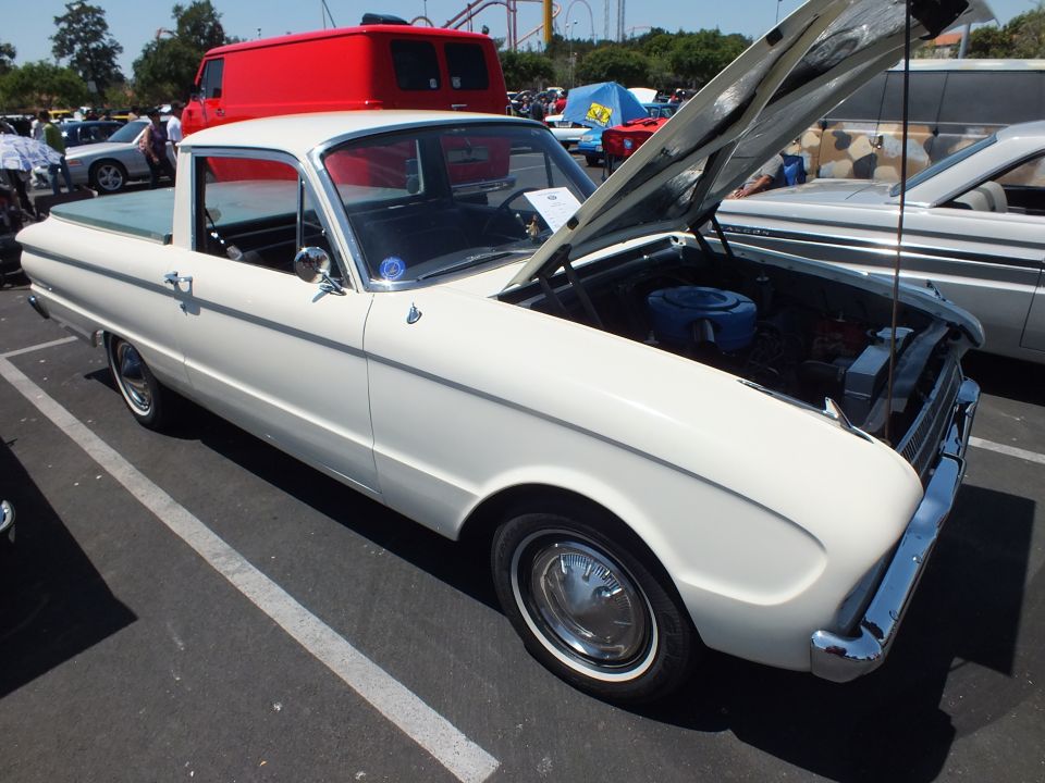 White early-1960s Ford Falcon Ranchero pickup with open hood at a car show