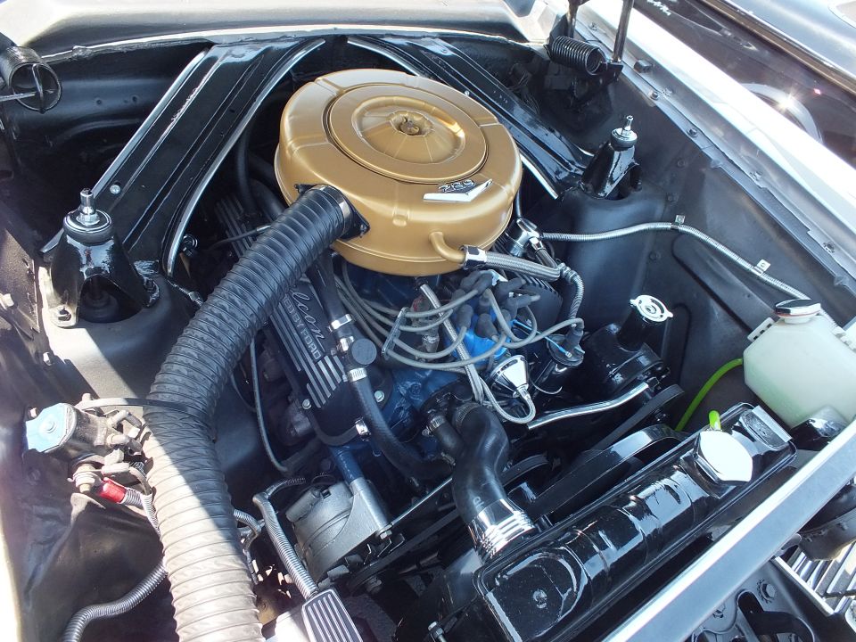 Engine bay close-up showing a gold air cleaner on a V8 with Ford branding