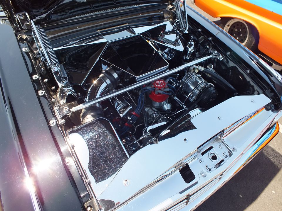 Highly detailed chromed and smoothed engine bay of a custom car
