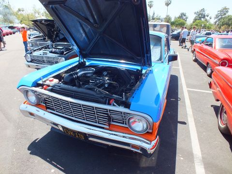 Blue-and-orange 1964 Ford Falcon with open hood, front view in a show lot