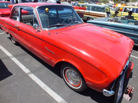 Red early-1960s Ford Falcon two-door sedan, front three-quarter at a car show