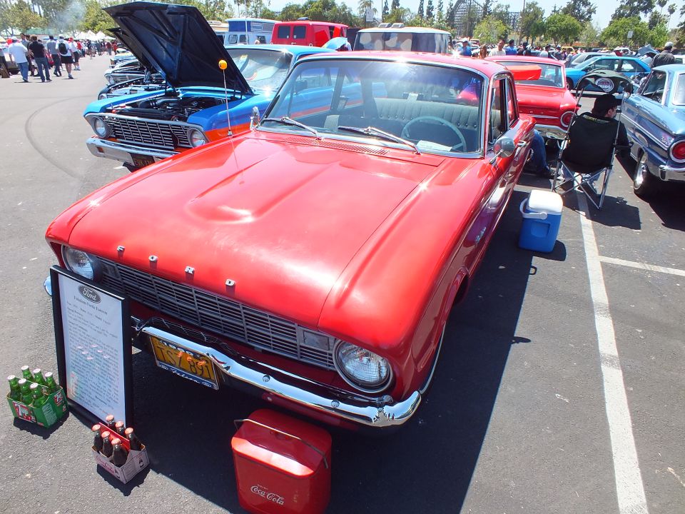 Red early-1960s Ford Falcon with FORD hood lettering and a Coca-Cola cooler