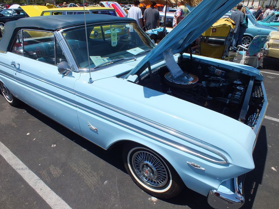 Light blue 1960s Ford Falcon convertible with black top and open hood