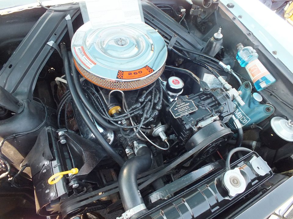Engine bay of a classic car with a chrome air cleaner labeled 260 V8