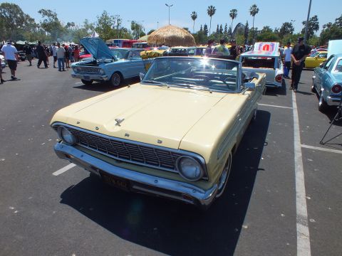 Front of cream Ford convertible with FORD lettered grille at a car show