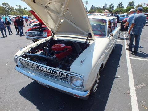 Cream compact sedan front three-quarter with hood up and red air cleaner
