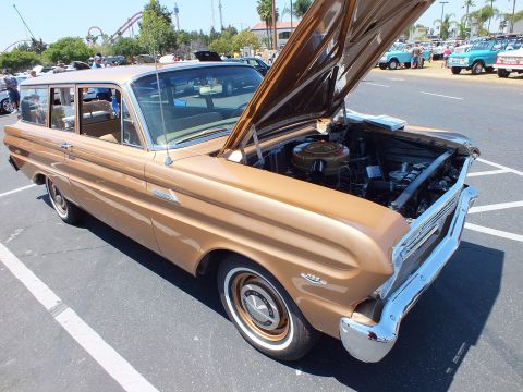 Bronze-gold two-door station wagon with hood open at a car show