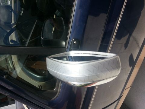1994 Ford Bronco - A custom side mirror with a diamond plate pattern is attached to the door of a dark blue vehicle.