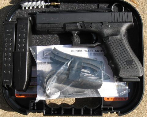 2000 Ford Crown Victoria - A Glock pistol, two magazines, and cleaning kit are neatly organized within its case.