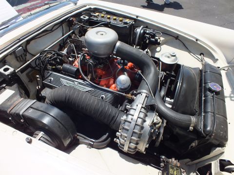 Engine bay close-up with finned valve covers, orange block and round air cleaner