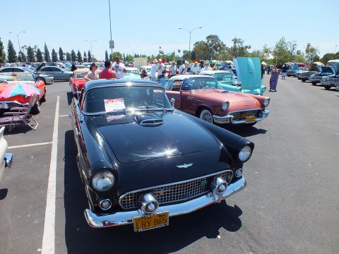 Black mid-1950s two-seat convertible hardtop front view at car show