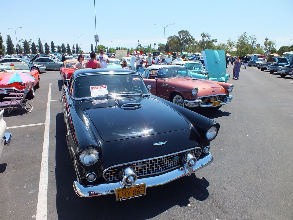 Black mid-1950s two-seat convertible hardtop front view at car show