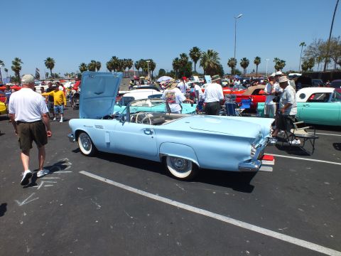 Light-blue two-seat convertible rear three-quarter with top down at car show
