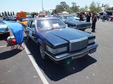 Dark-blue 1980s personal-luxury coupe front three-quarter at car show
