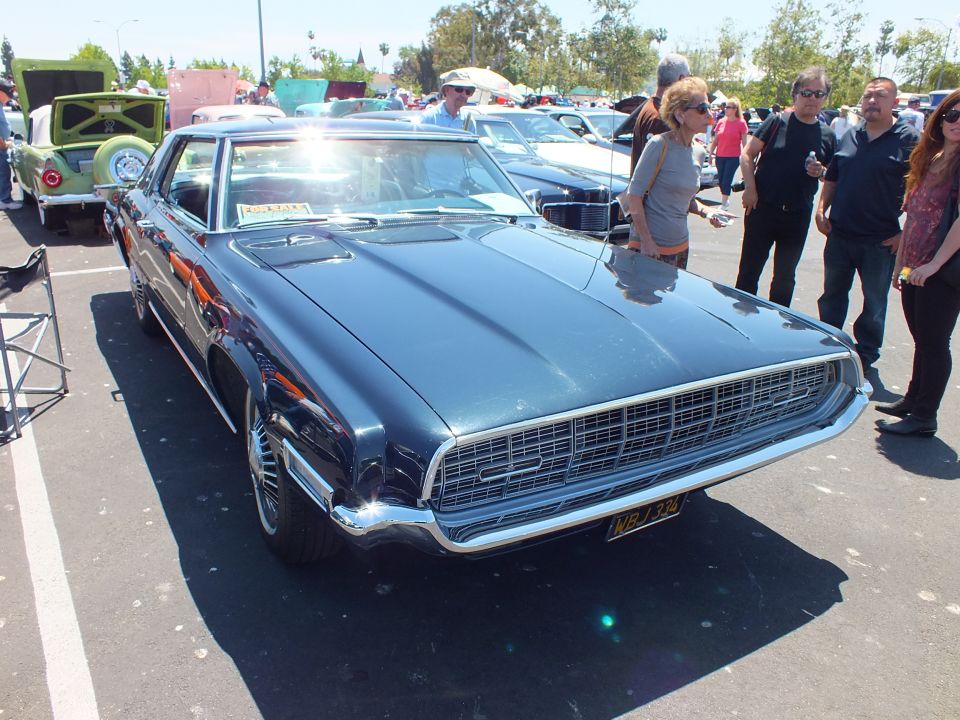 Dark blue late-1960s personal-luxury coupe front three-quarter at car show