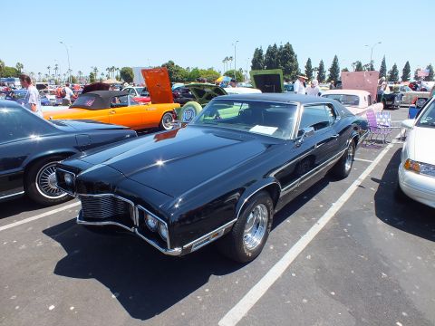 Black 1970s personal-luxury coupe front three-quarter at car show