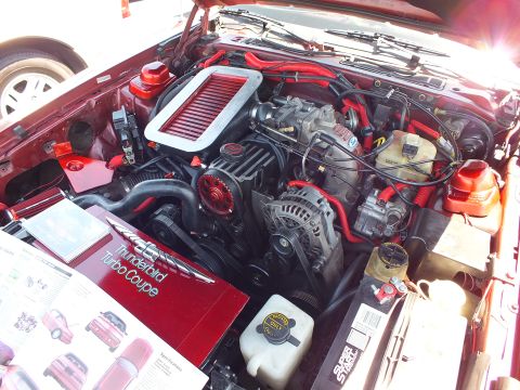 Close-up of engine bay with red accents and 'Thunderbird Turbo Coupe' placard