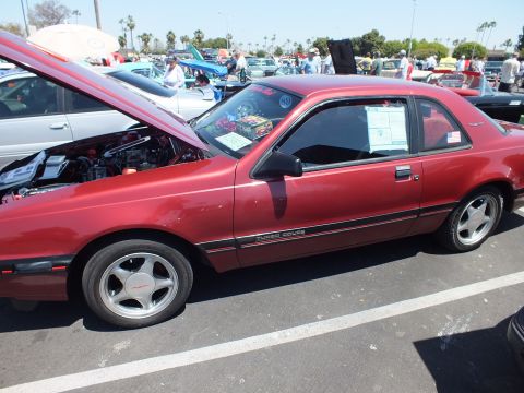 Side view of dark red Ford Thunderbird Turbo Coupe at a car show