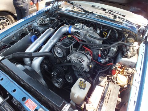 Close-up of a turbocharged engine bay in a blue car