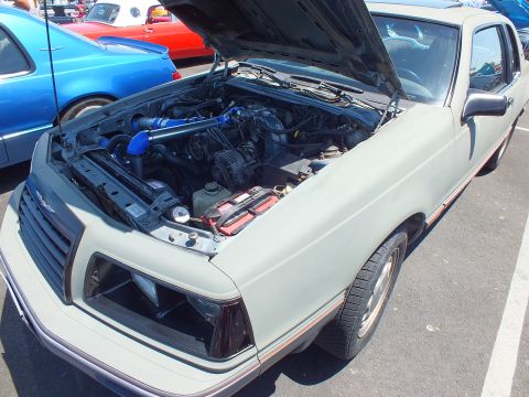 Light gray coupe with open hood showing blue intercooler piping