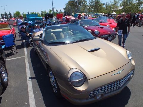 Gold Ford Thunderbird convertible front three-quarter at a car show