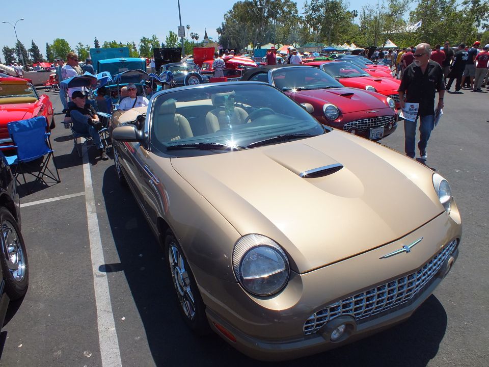 Gold Ford Thunderbird convertible front three-quarter at a car show