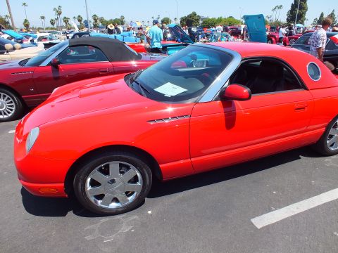 Red Ford Thunderbird hardtop convertible with porthole top at a show