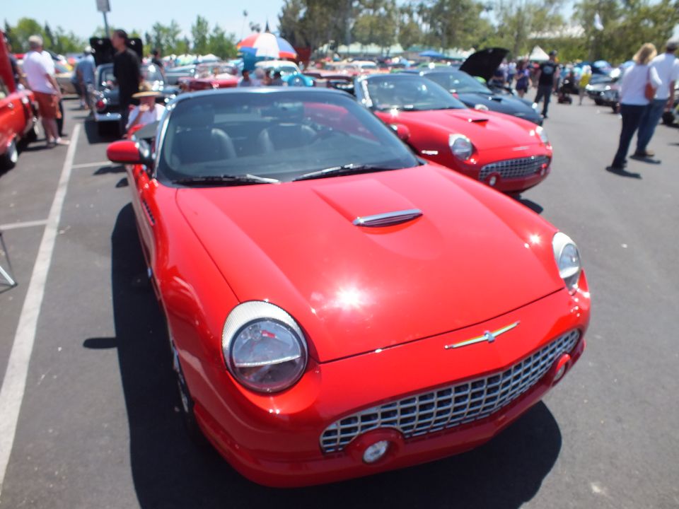 Red retro-styled two-seat convertible front view at outdoor car show