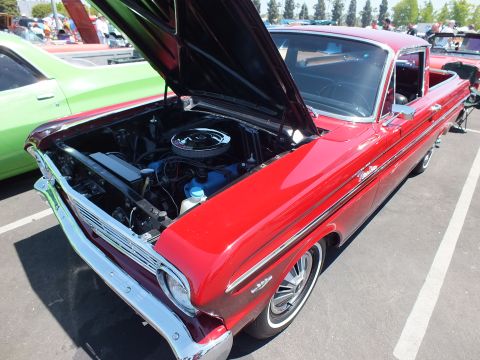 Red classic car-based pickup with hood open showing engine bay