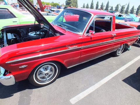 Red Ford Ranchero car-based pickup side view at car show