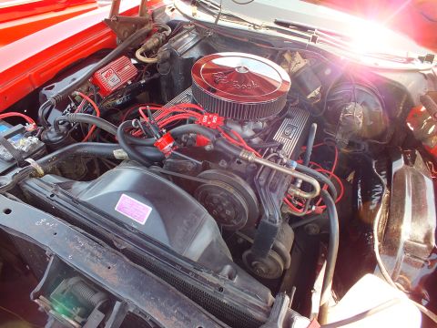 Close-up of V8 engine with Edelbrock air cleaner and red plug wires