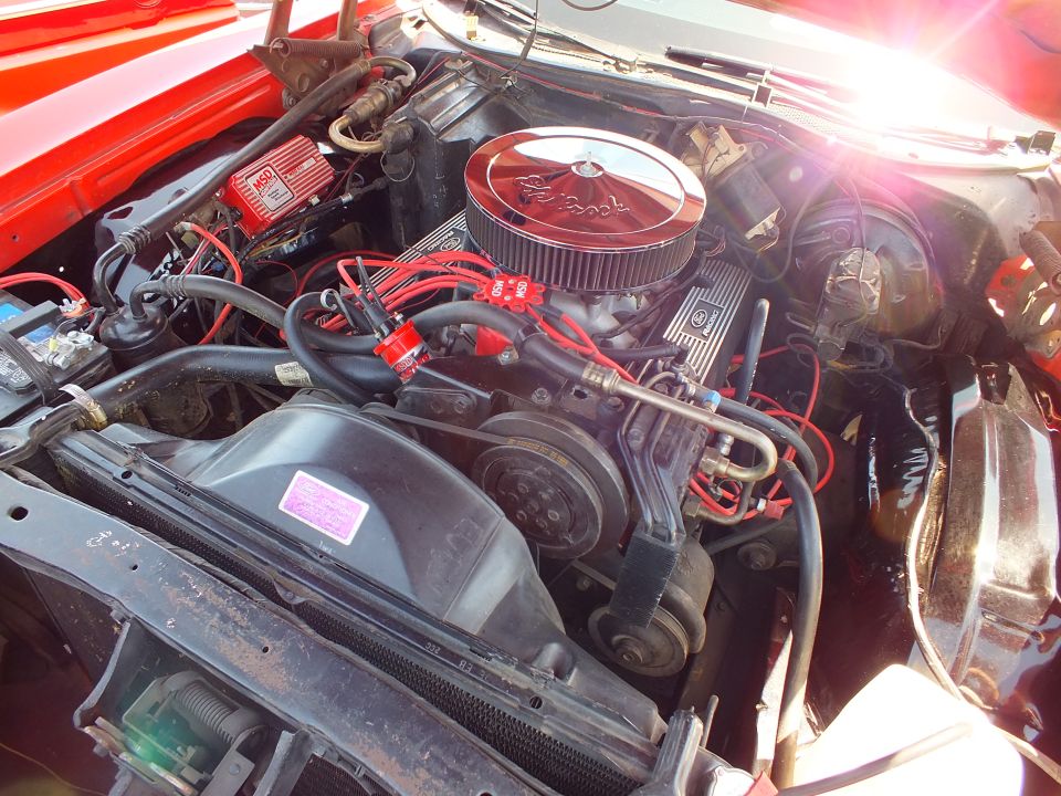 Close-up of V8 engine with Edelbrock air cleaner and red plug wires