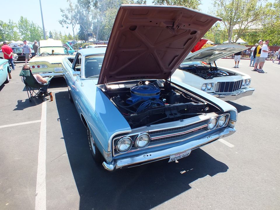 Light blue car-based pickup with open hood showing blue air cleaner