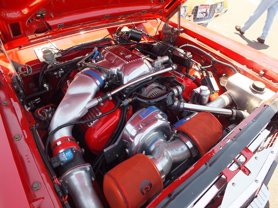 Engine bay with polished centrifugal supercharger and red air filters