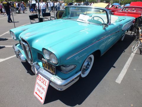 Turquoise 1958 Edsel convertible with Edsel Parking Only sign at a car show