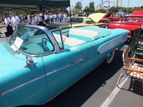 Turquoise and white 1950s Edsel convertible side view at an outdoor car show