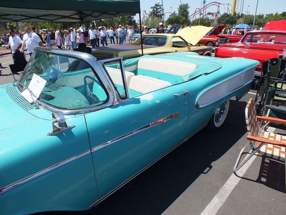 Turquoise and white 1950s Edsel convertible side view at an outdoor car show