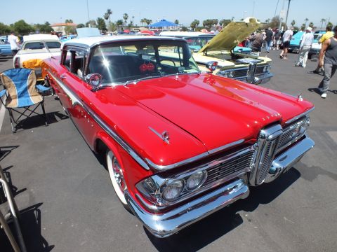 Red 1959 Edsel sedan with horse-collar grille at an outdoor car show